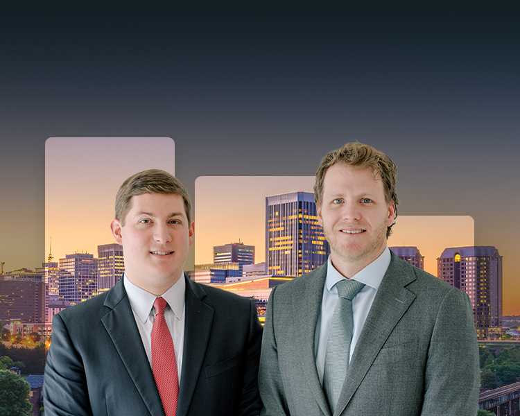 Attorneys Bay Lawrence and Cameron McCormick standing in front of a city skyline.